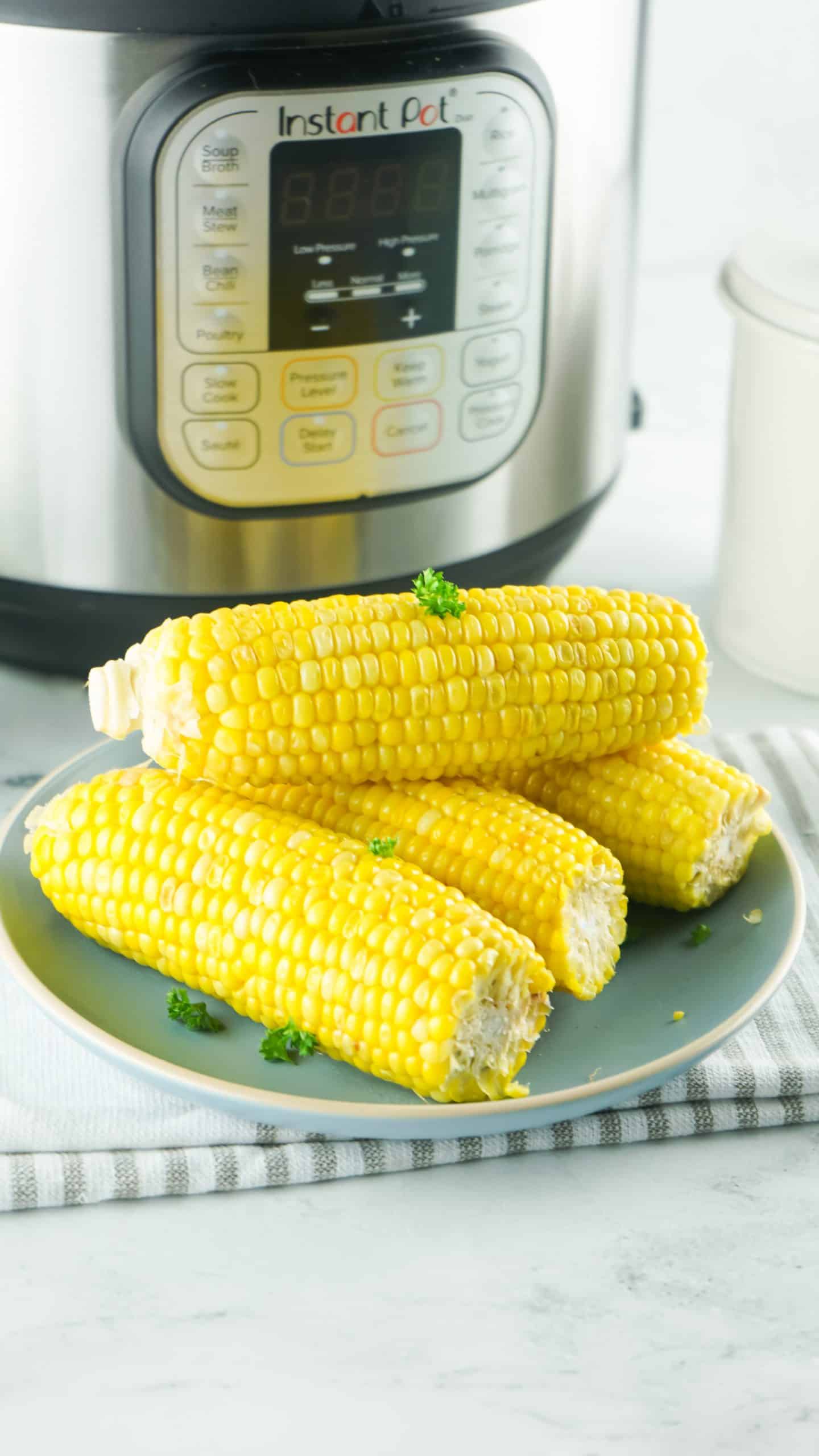 Corn on cob in front of Instant Pot.