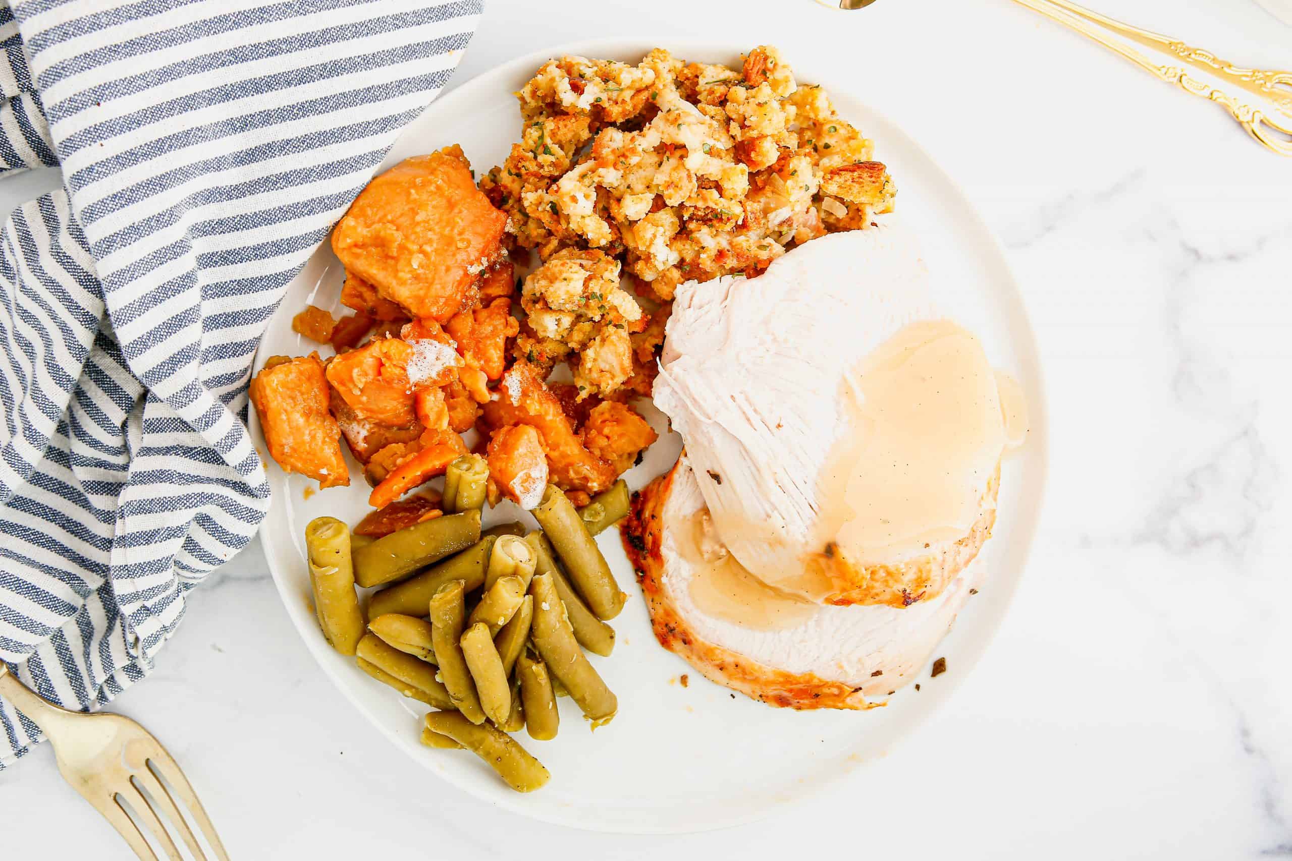 Overhead view of turkey dinner with gravy.