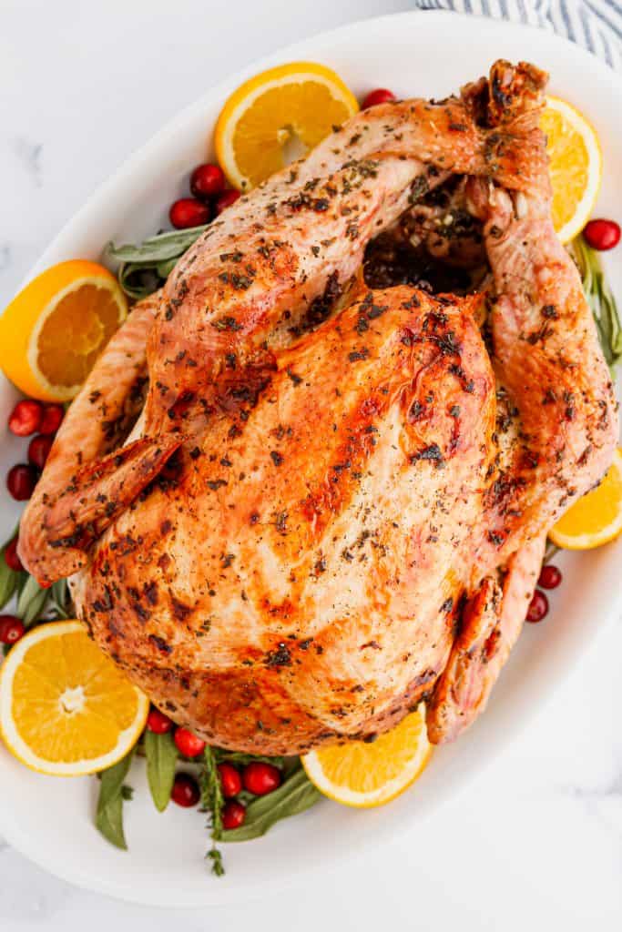 Overhead view of Herb Butter Turkey on a white platter.