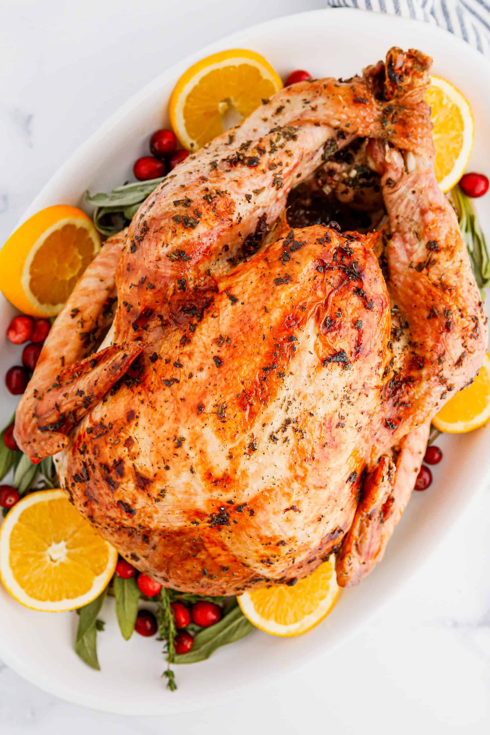 Overhead view of Herb Butter Turkey on a white platter.
