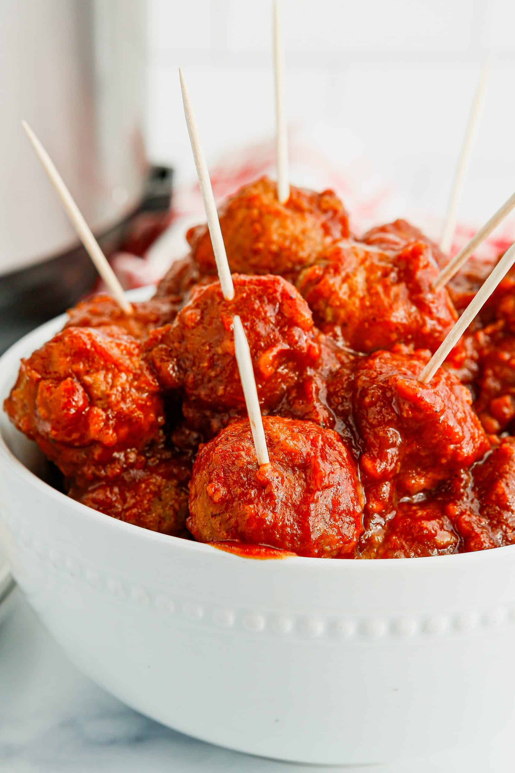 Cranberry meatballs with toothpicks.
