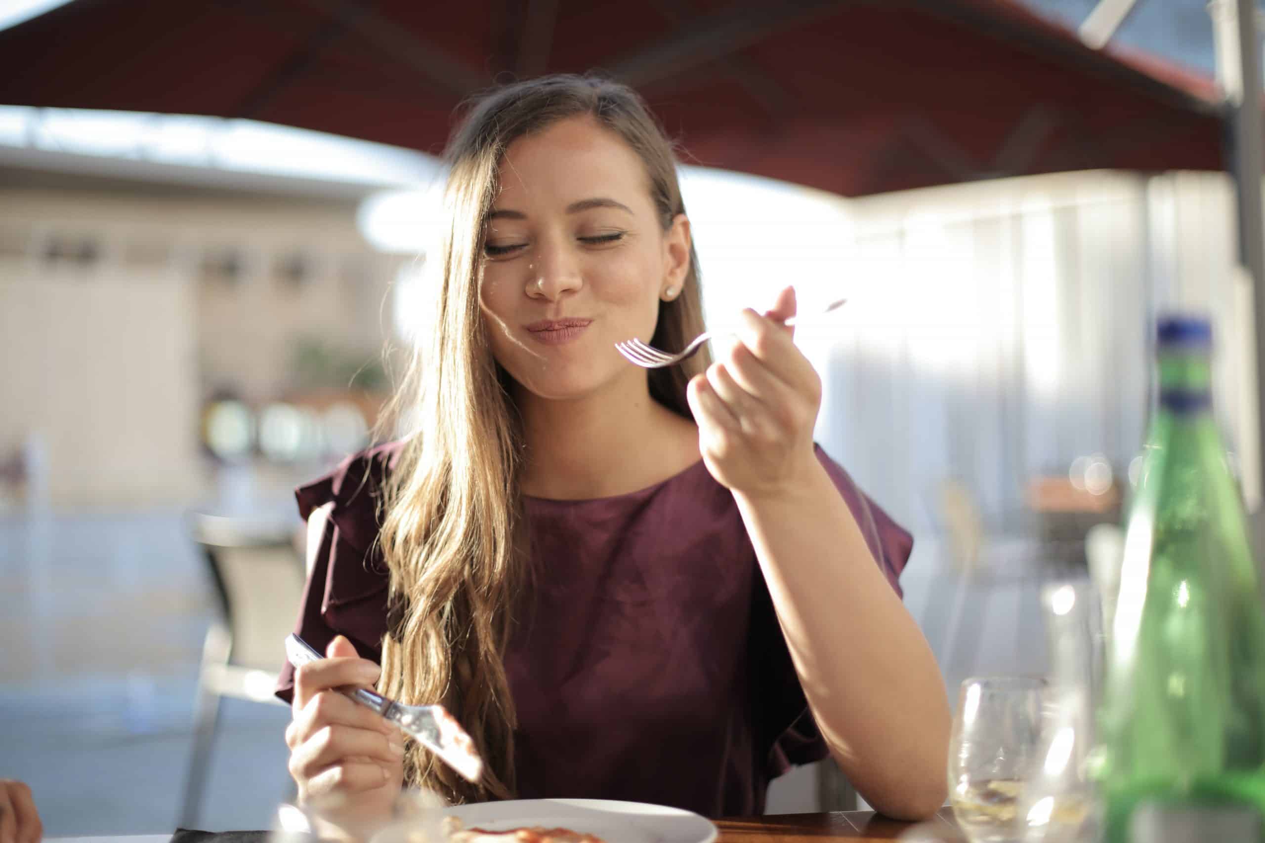 Girl eating and smiling.