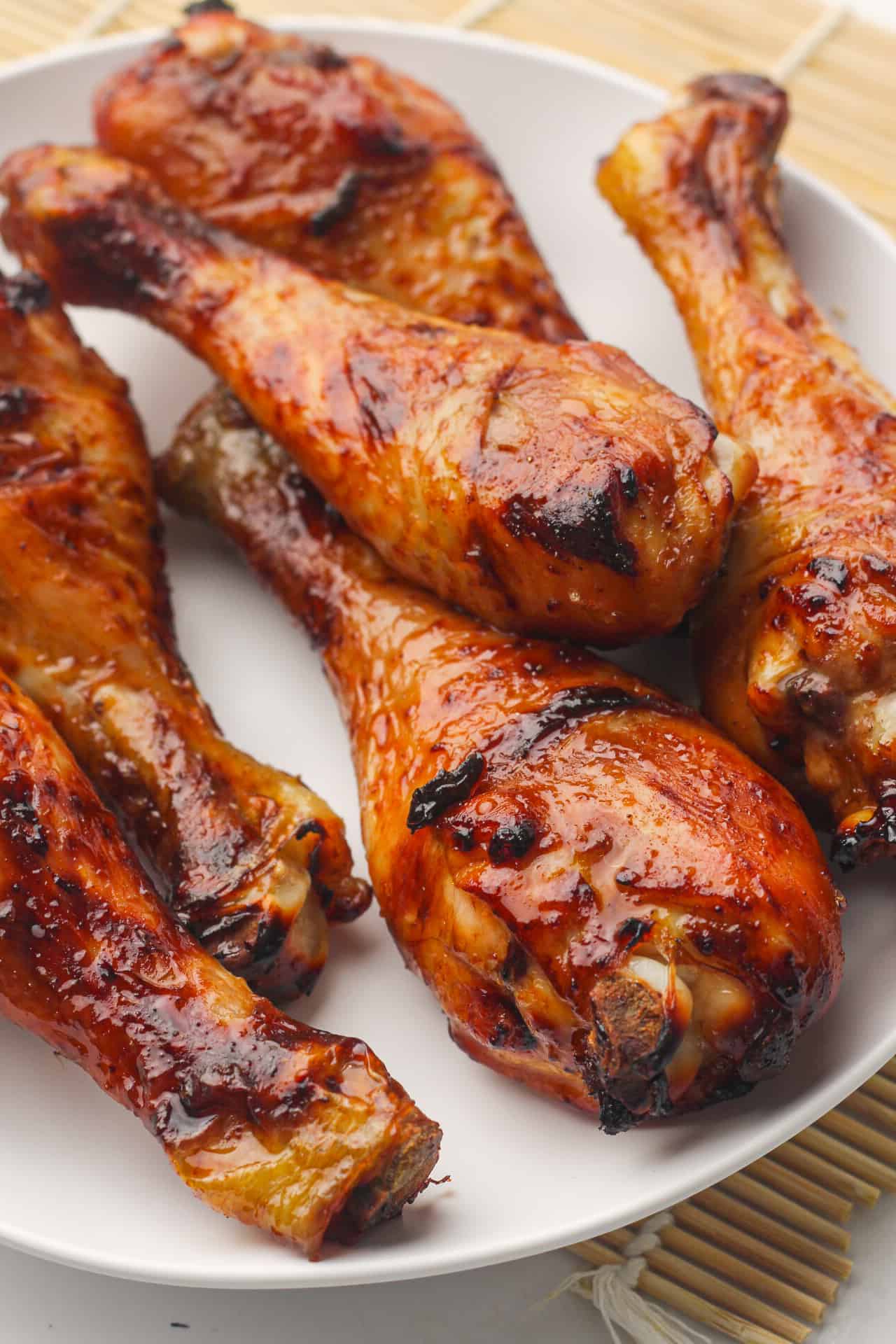 Closeup of honey-soy glazed chicken drumsticks.