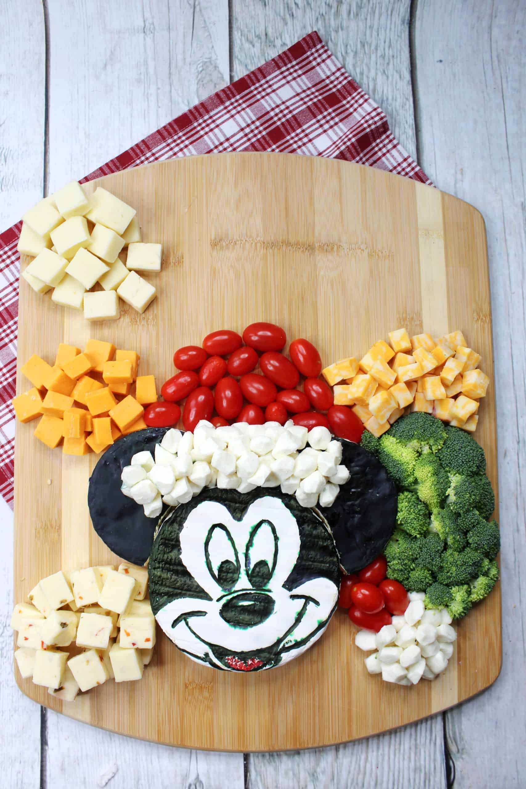 Arranging cheese cubes around Santa Mickey.