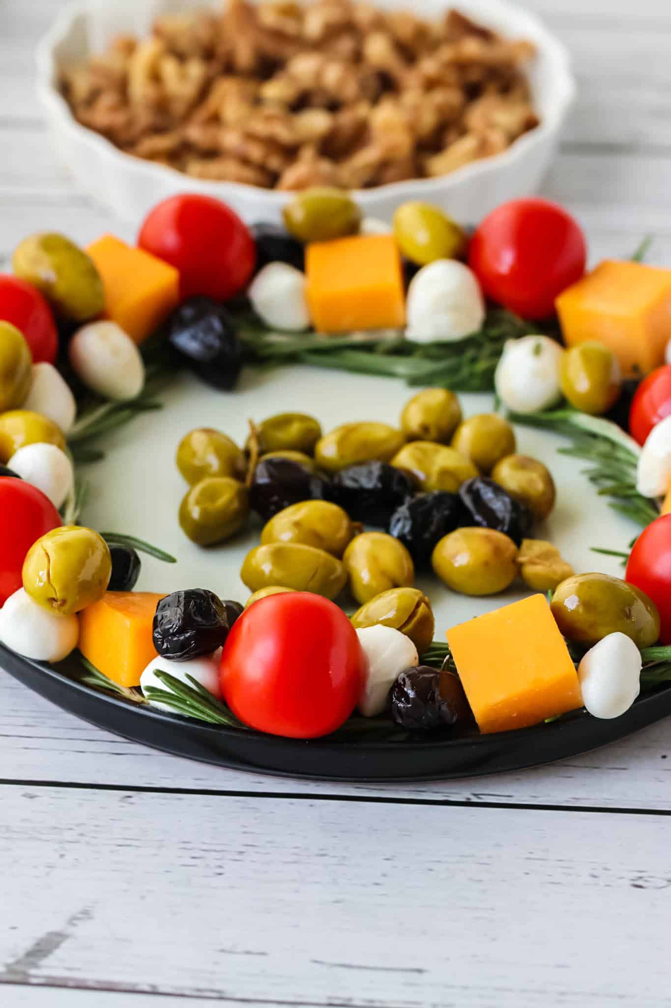 Final wreath charcuterie with olives in the center.