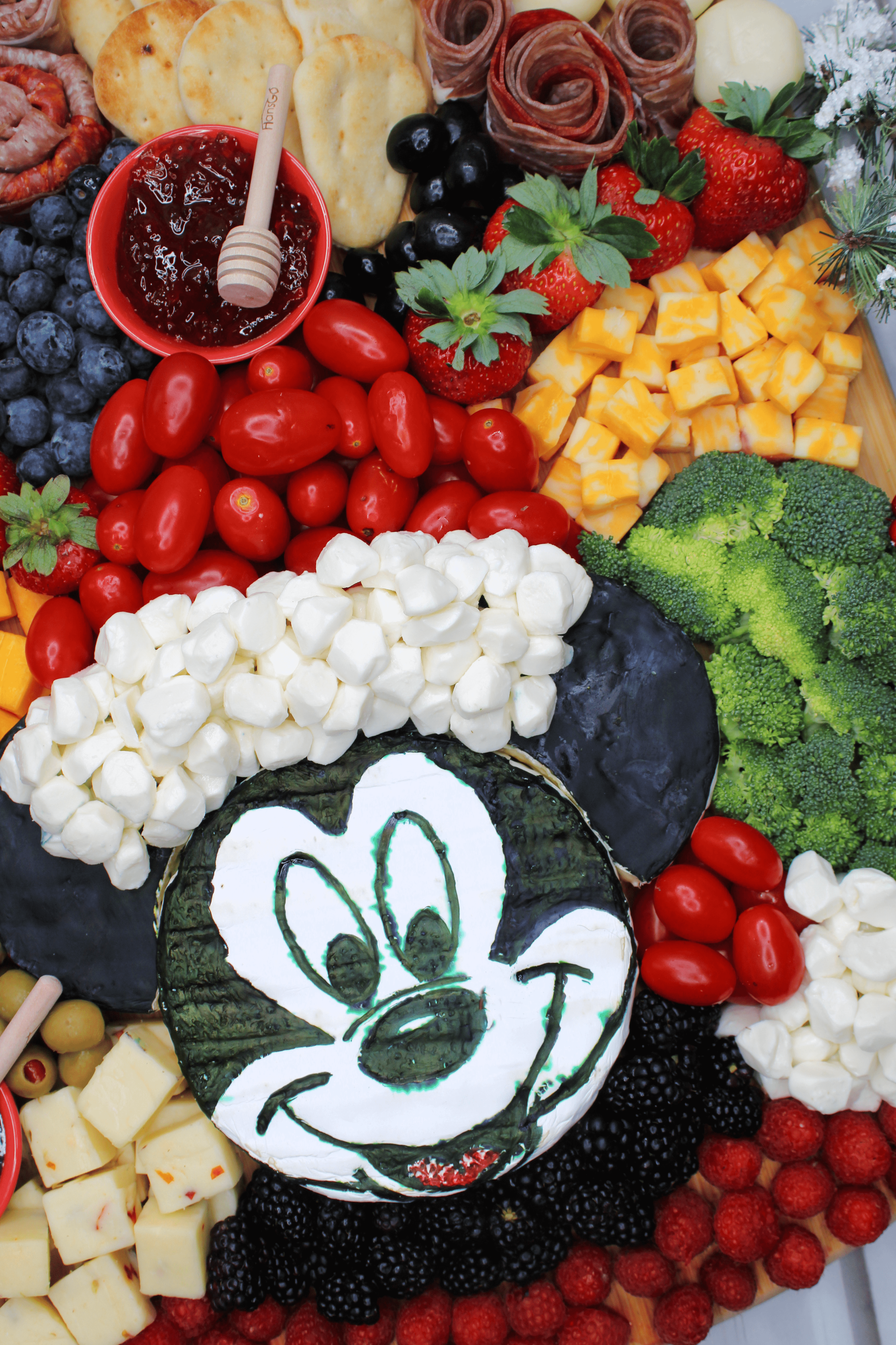 Charcuterie board for Christmas with Santa Mickey Mouse in the center.
