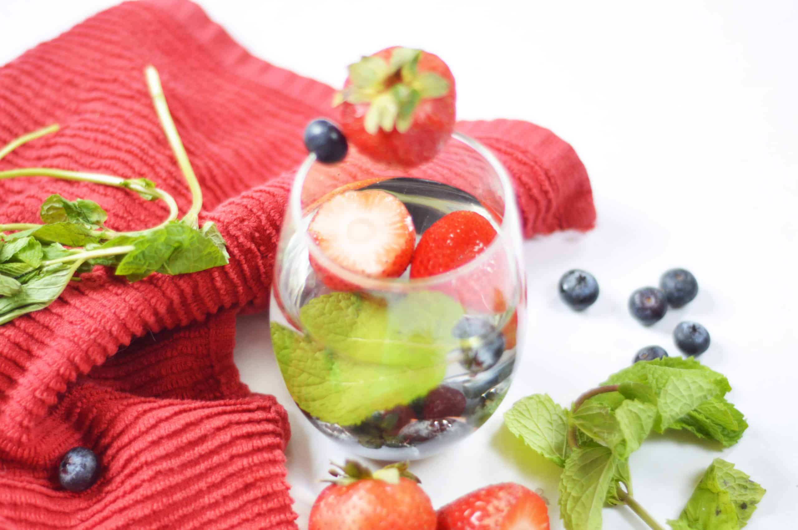 angled over head view of strawberry blueberry mint water.