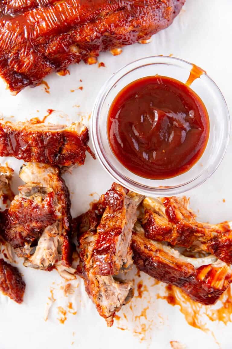 Overhead view of baby back ribs with sauce.y