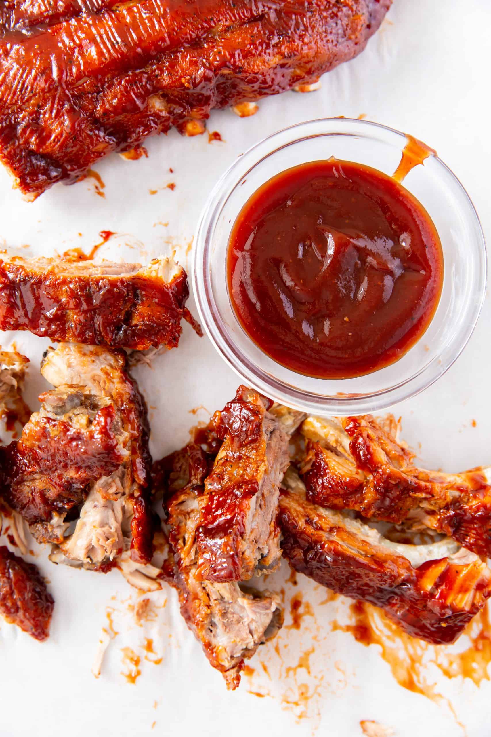 Overhead view of baby back ribs with sauce.y