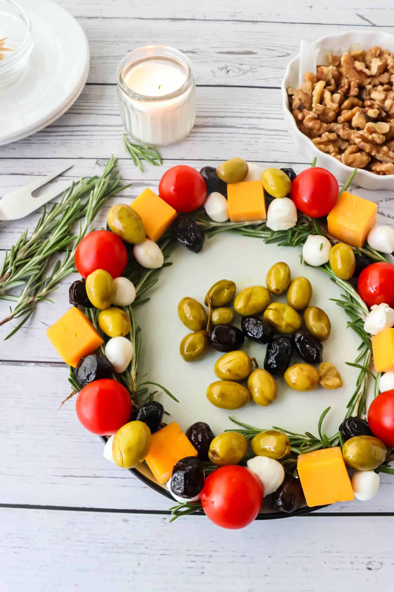 Overhead view of olive, cheese & tomato wreath.