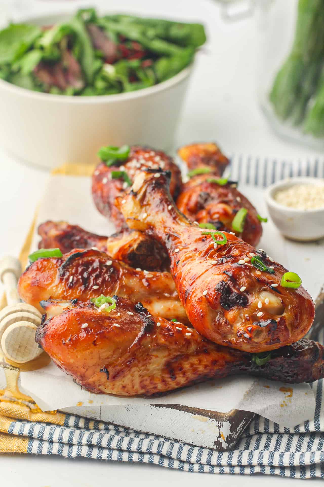 Soy glazed chicken drumsticks on a white plate.