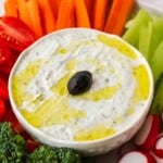 Greek yogurt dip surrounded by vegetables.