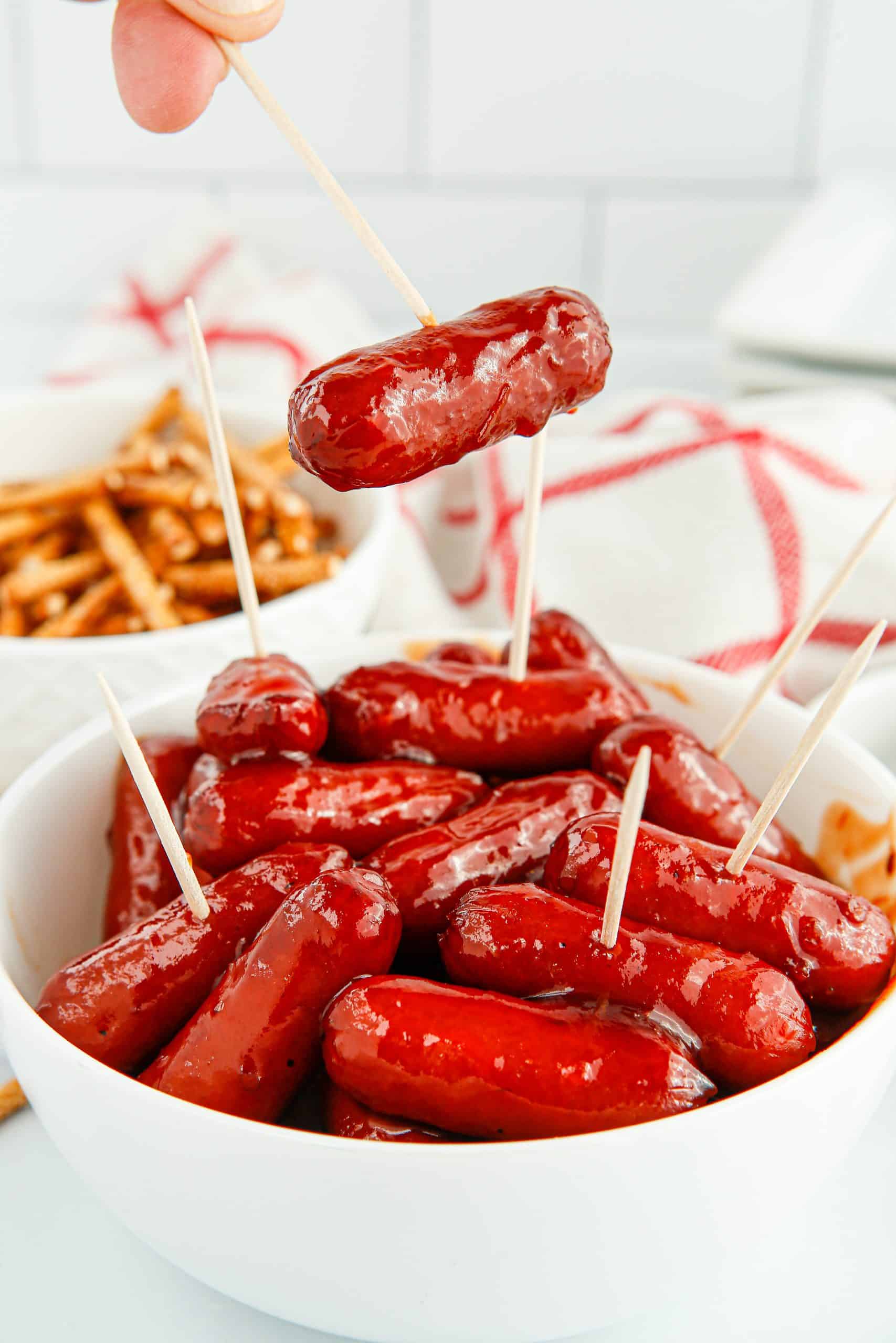 Mini hot dogs on toothpicks.