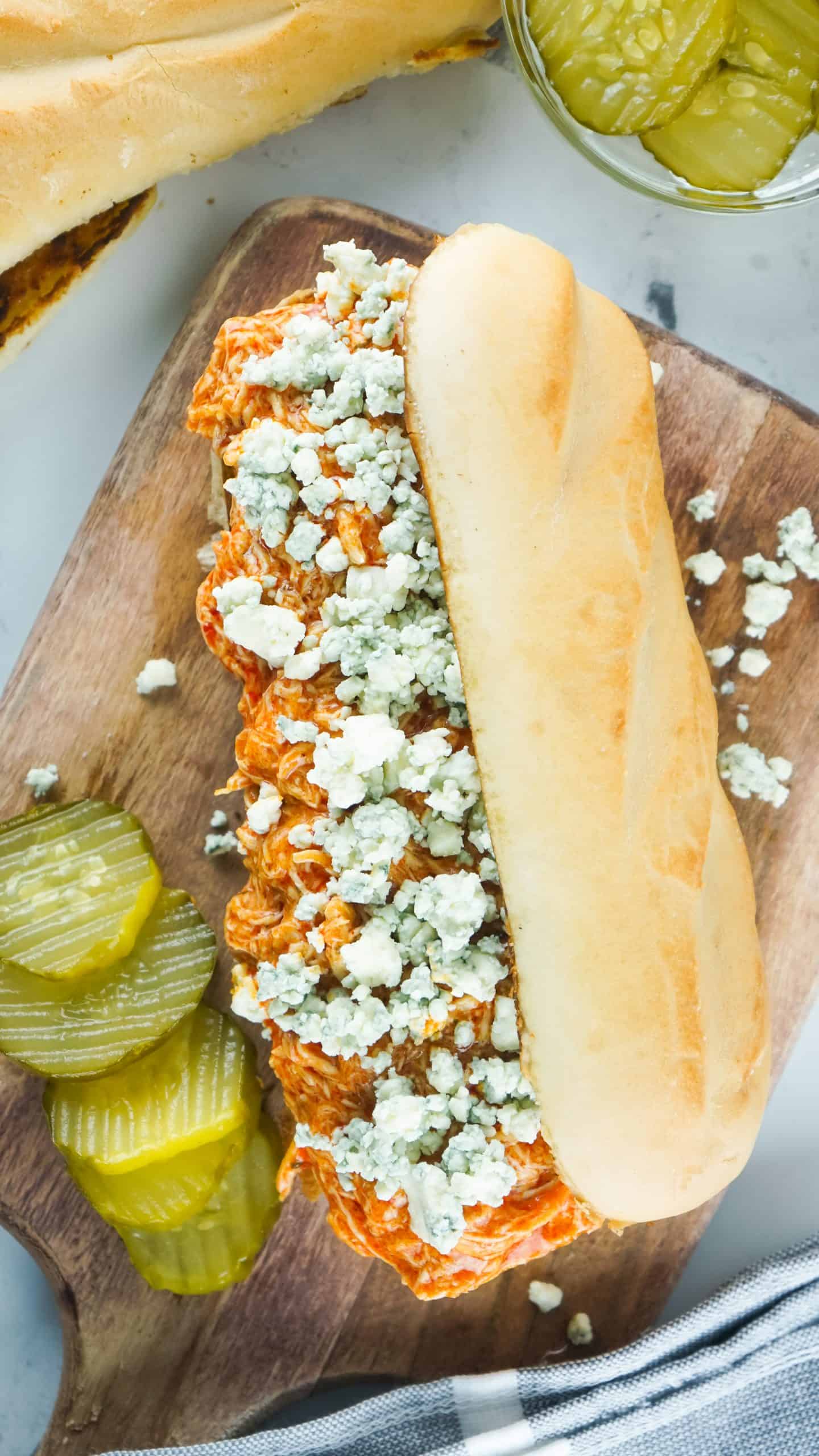 Submarine sandwich with Buffalo chicken and blue cheese on top.