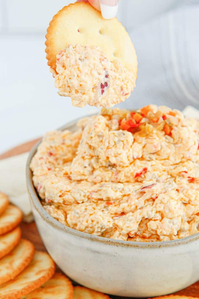 Dipping a cracker into pickled vegetable dip.