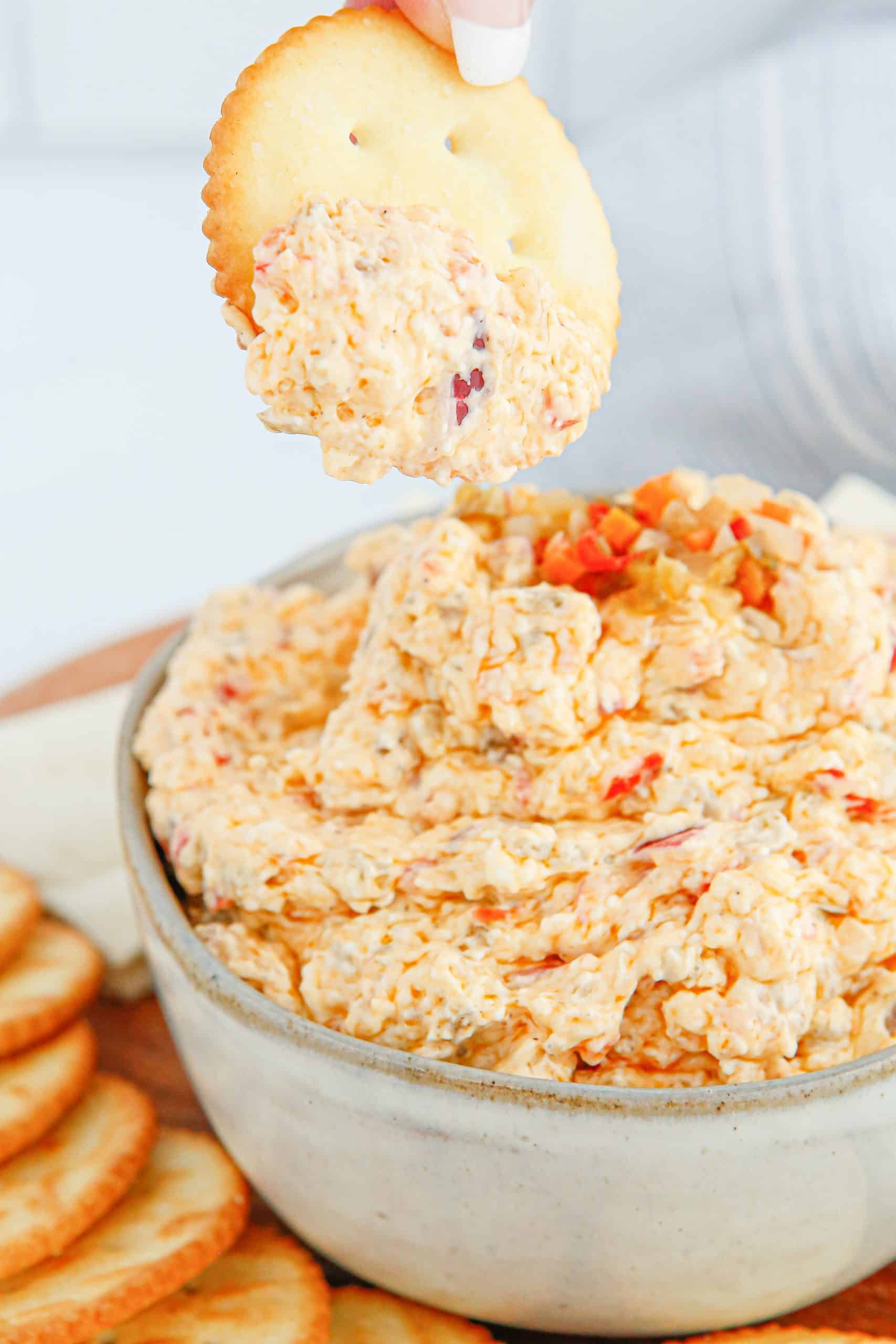 Dipping a cracker into pickled vegetable dip.