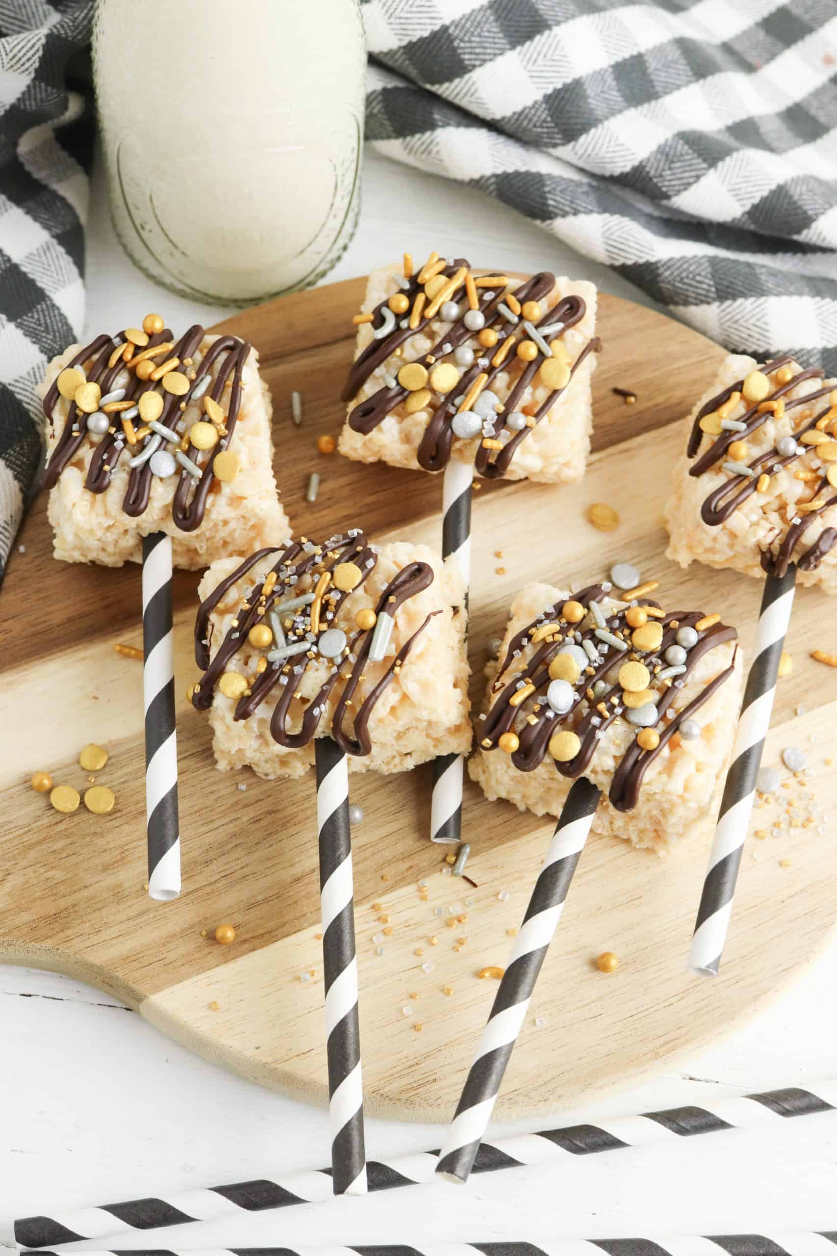 Overhead view or Rice Krispies Treats on striped sticks. Decorated for New Year's Eve.