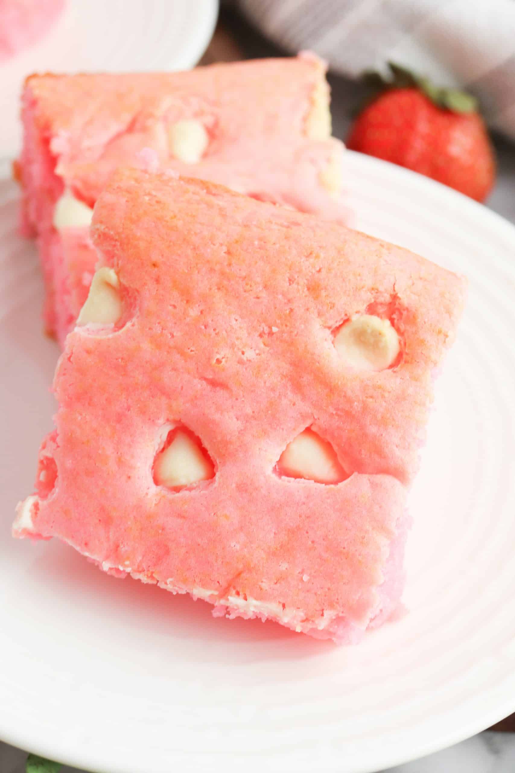 Closeup of pink brownies with white chocolate chips.