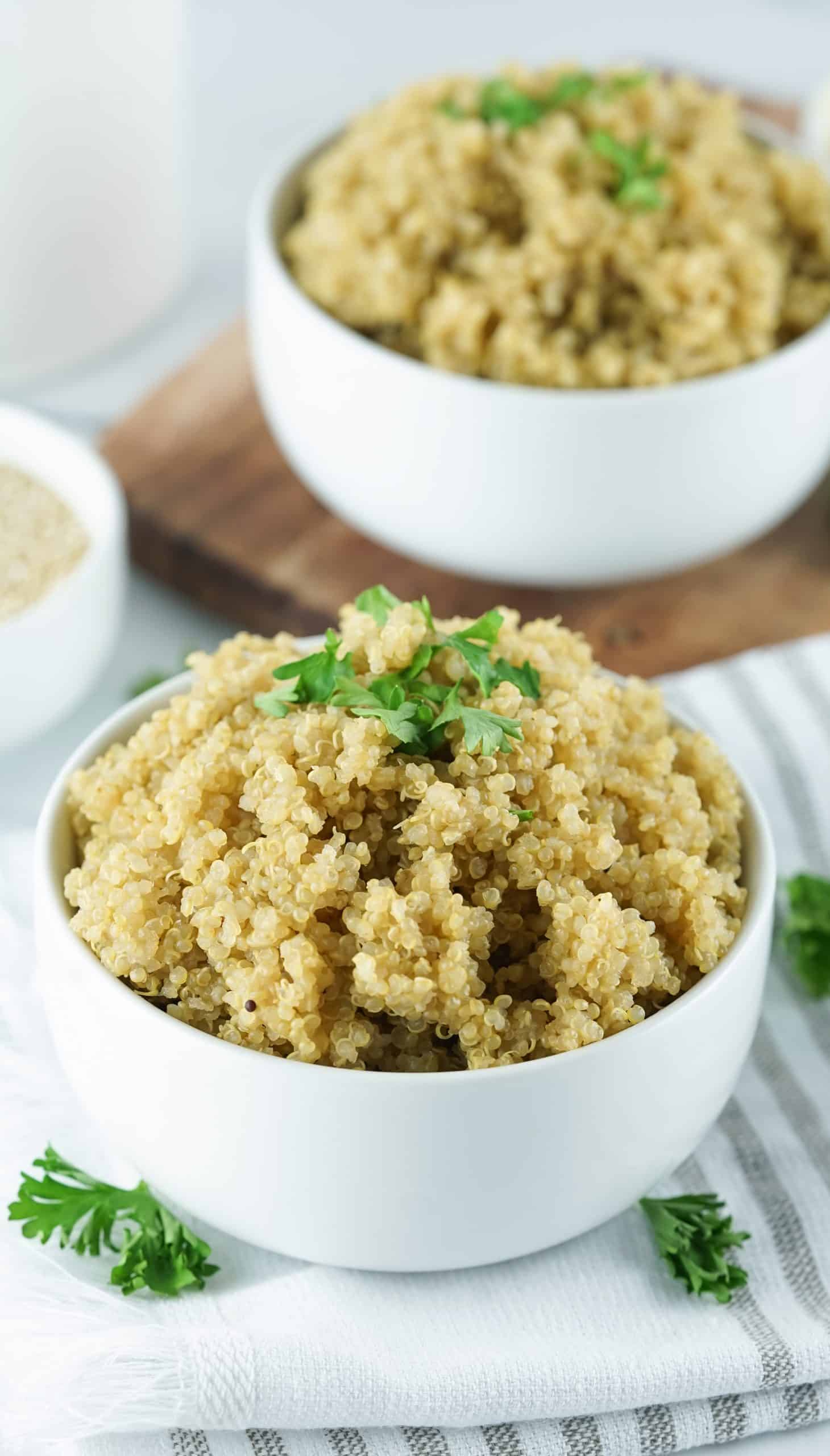 2 white bowls filled with quinoa.