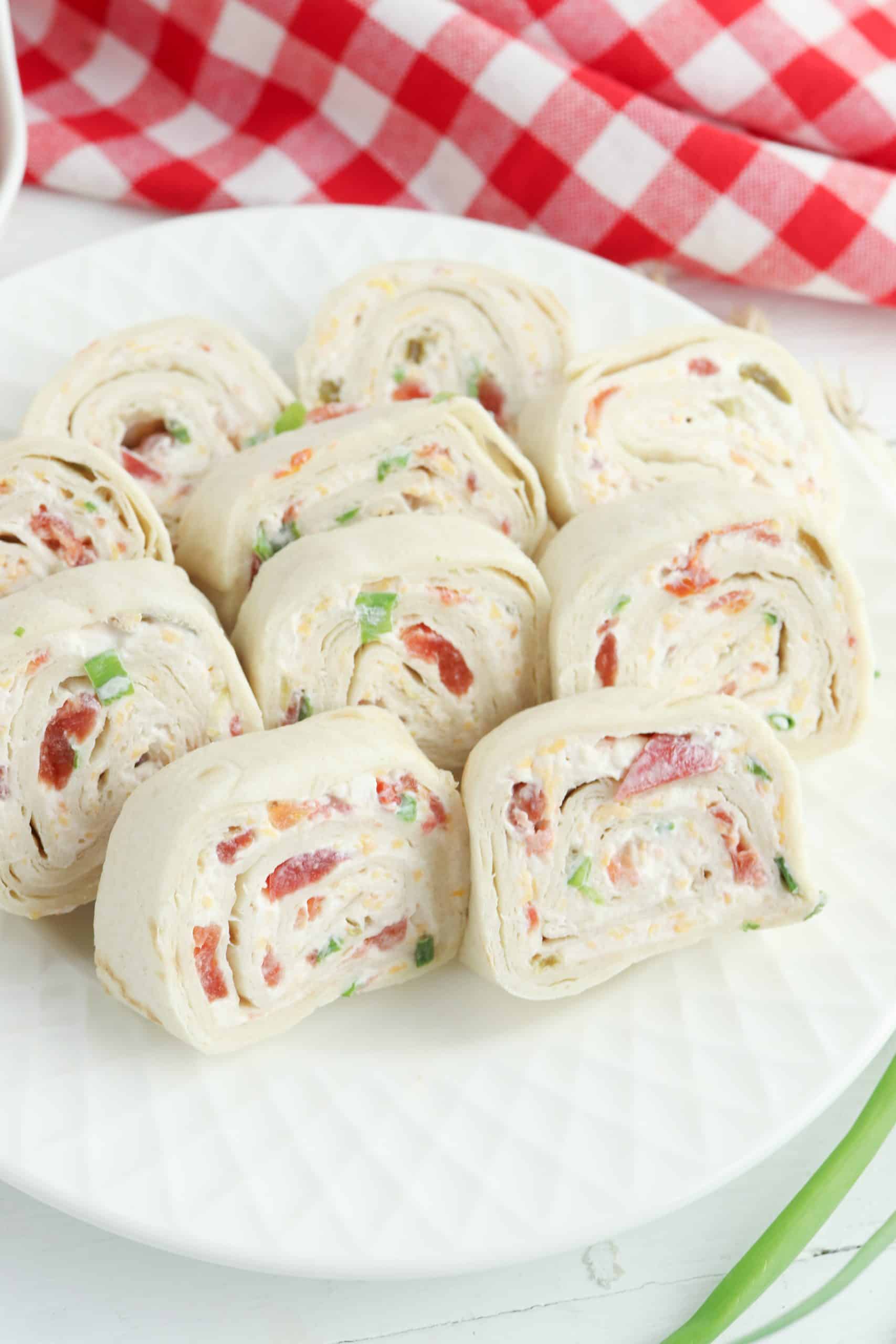 Pinwheel appetizers on a white plate.
