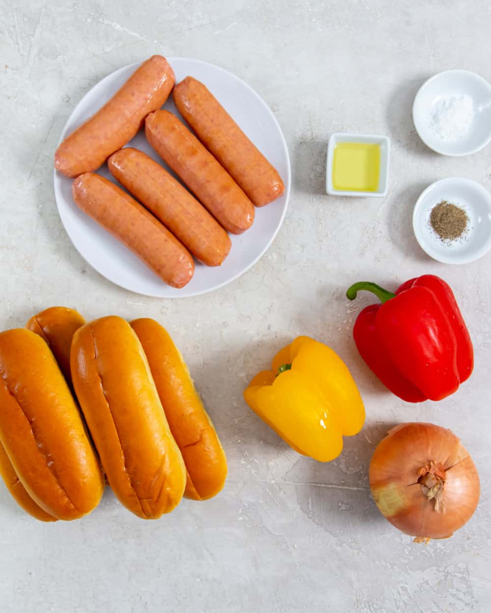 Overhead view of sausage and peppers ingredients.