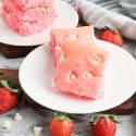 Valentine's Day Strawberry Brownies with White Chocolate Chips on a white plate.
