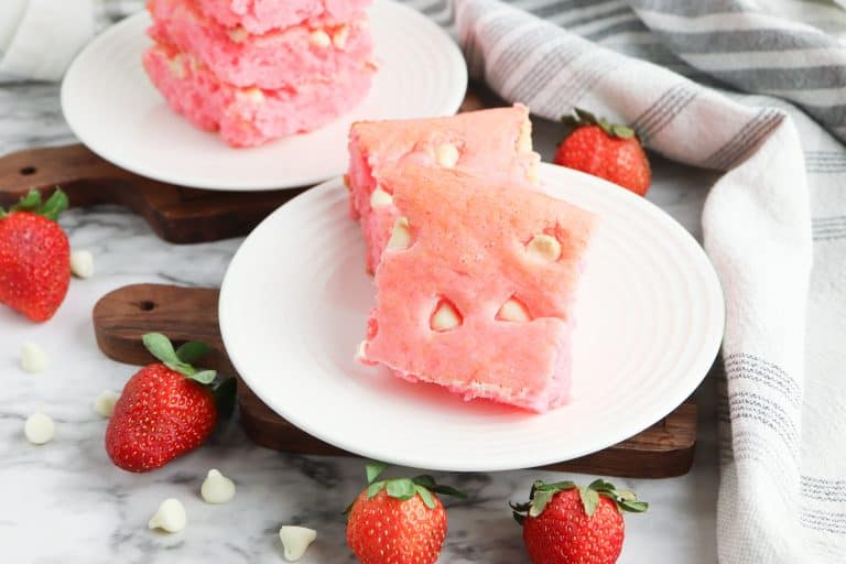 Valentine's Day Strawberry Brownies with White Chocolate Chips on a white plate.
