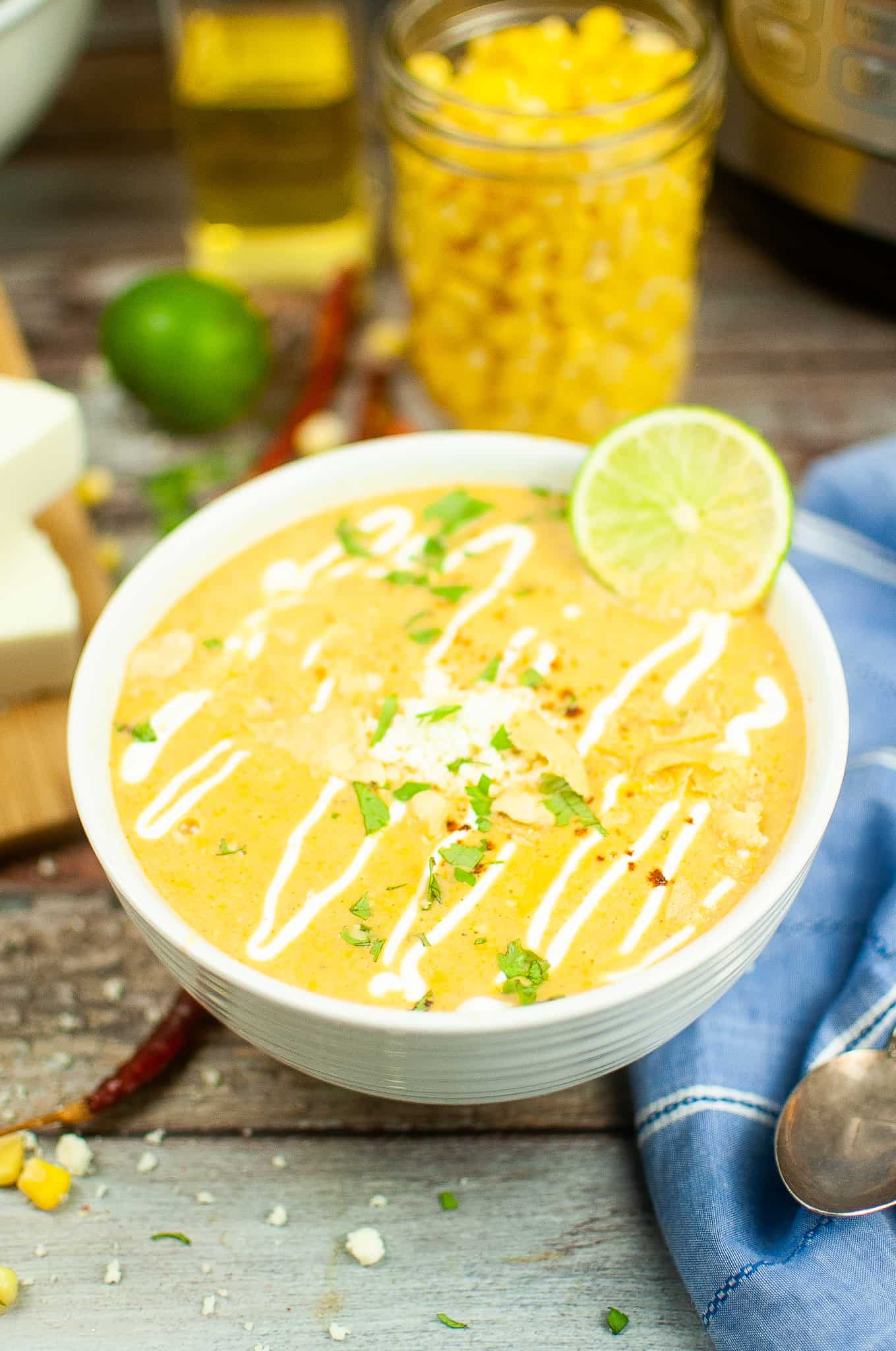 Instant Pot Street Corn Soup in a white bowl wit a slice of lime.