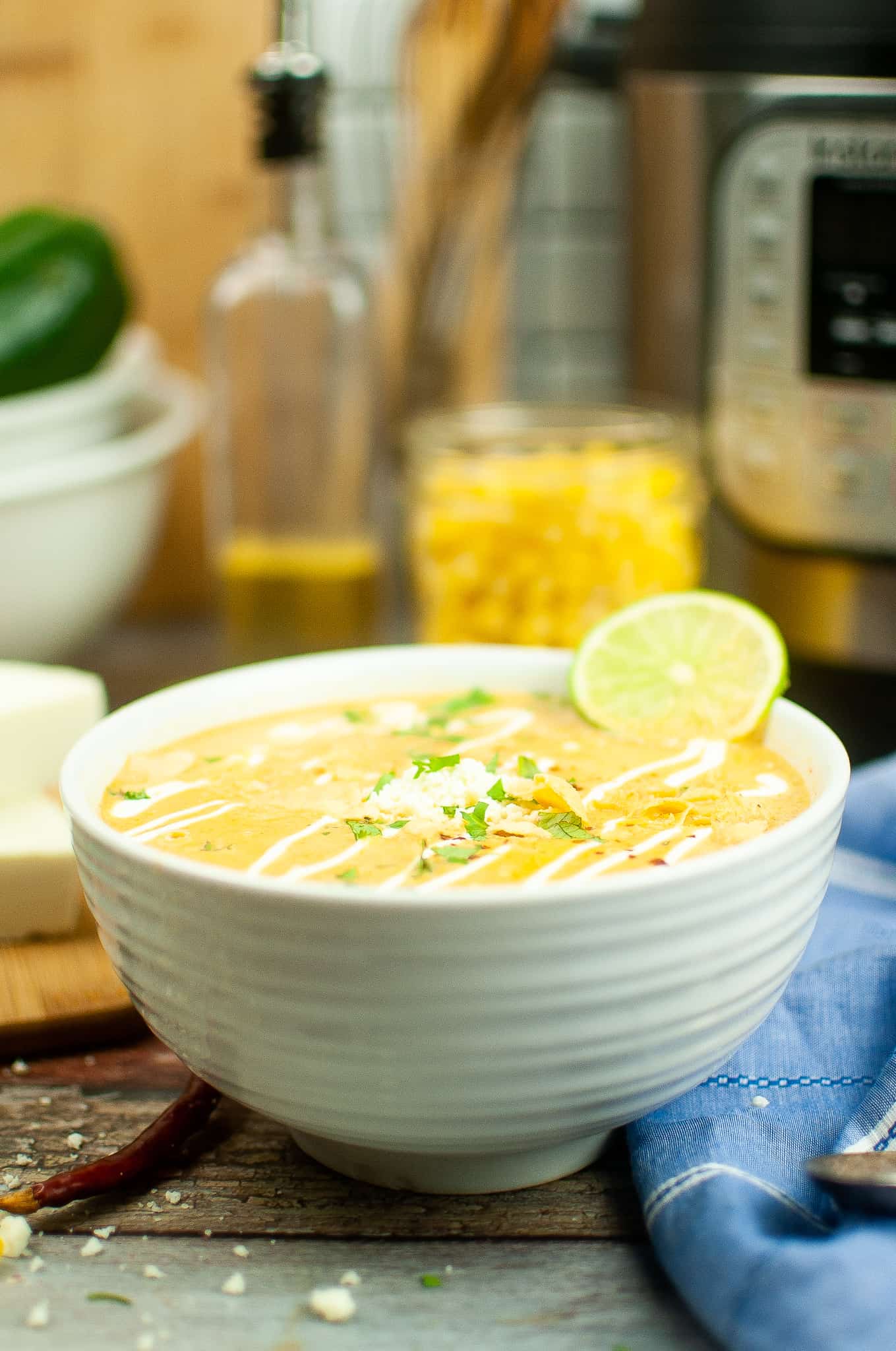 Street Corn Soup in a white bowl in front of Instant Pot.