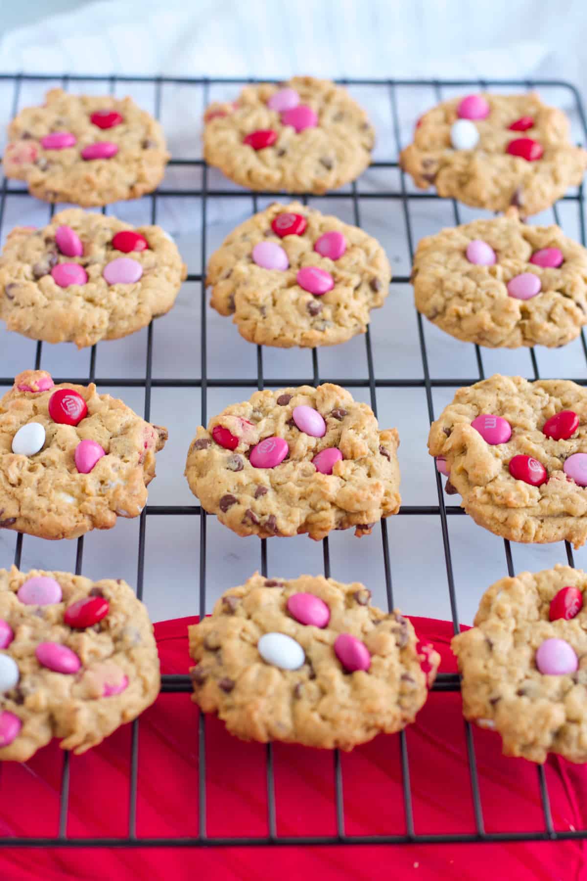 Valentine's Cookies with M & M's on a cooling rack.