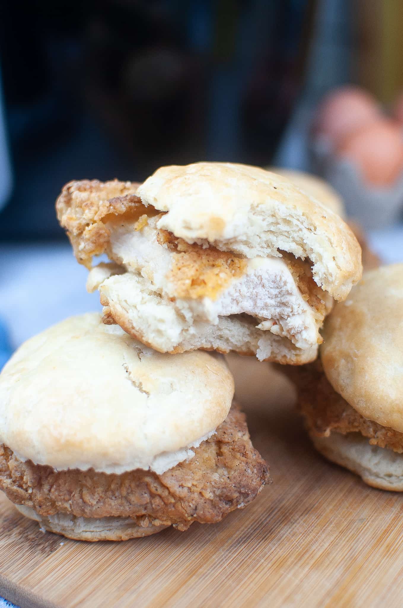 Chicken biscuit sandwich with a bite out of it.
