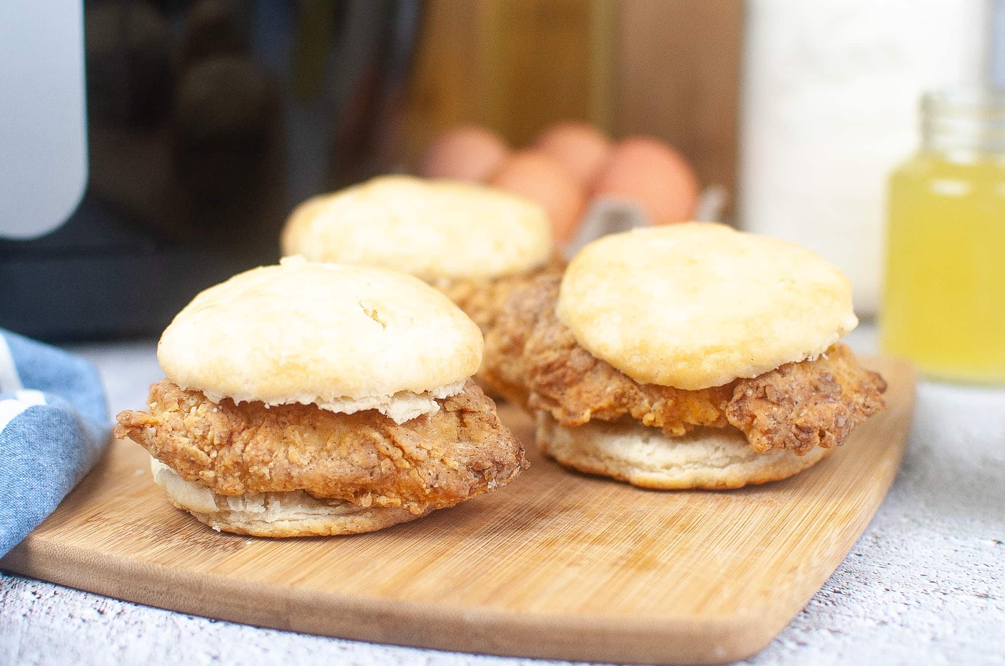 3 Copycat Chick-fil-a sandwiches on a cutting board.