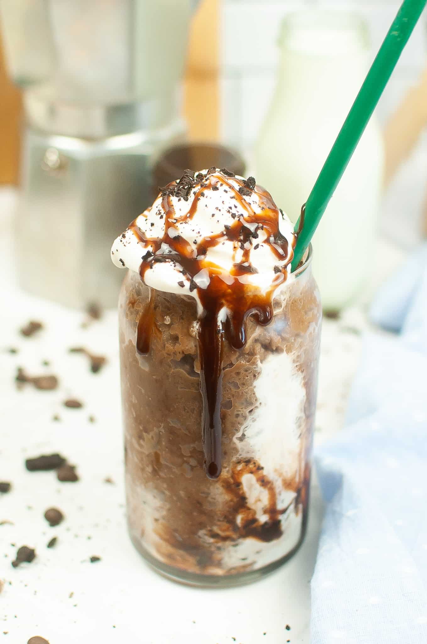 Head on view of frappuccino with whipped cream and chocolate drizzle.