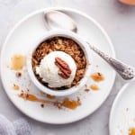 Overhead view of Air Fryer Apple Crisp with Ice Cream on top of it.