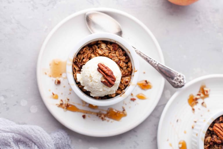 Overhead view of Air Fryer Apple Crisp with Ice Cream on top of it.