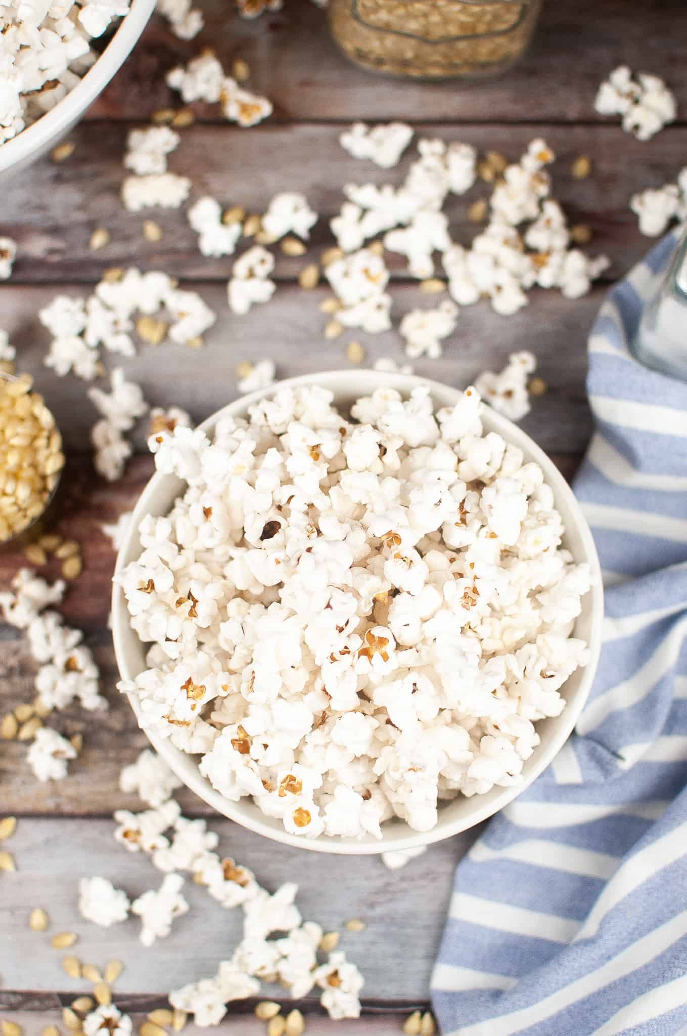 Overhead view of air fryer popcorn in a white bowl.