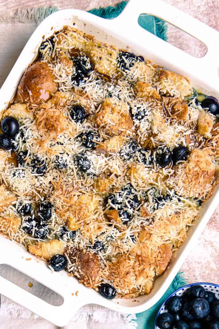 Overhead view of breakfast casserole with blueberries & coconut.