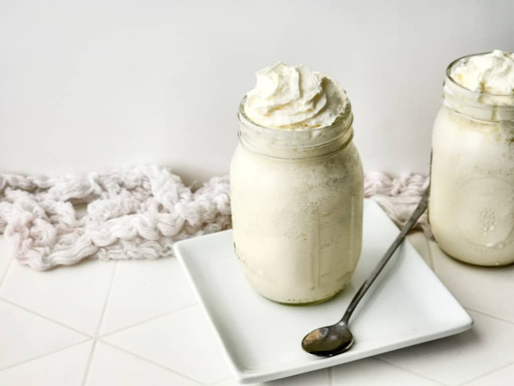Vanilla Bean Frappuccino on a white plate with a silver spoon.