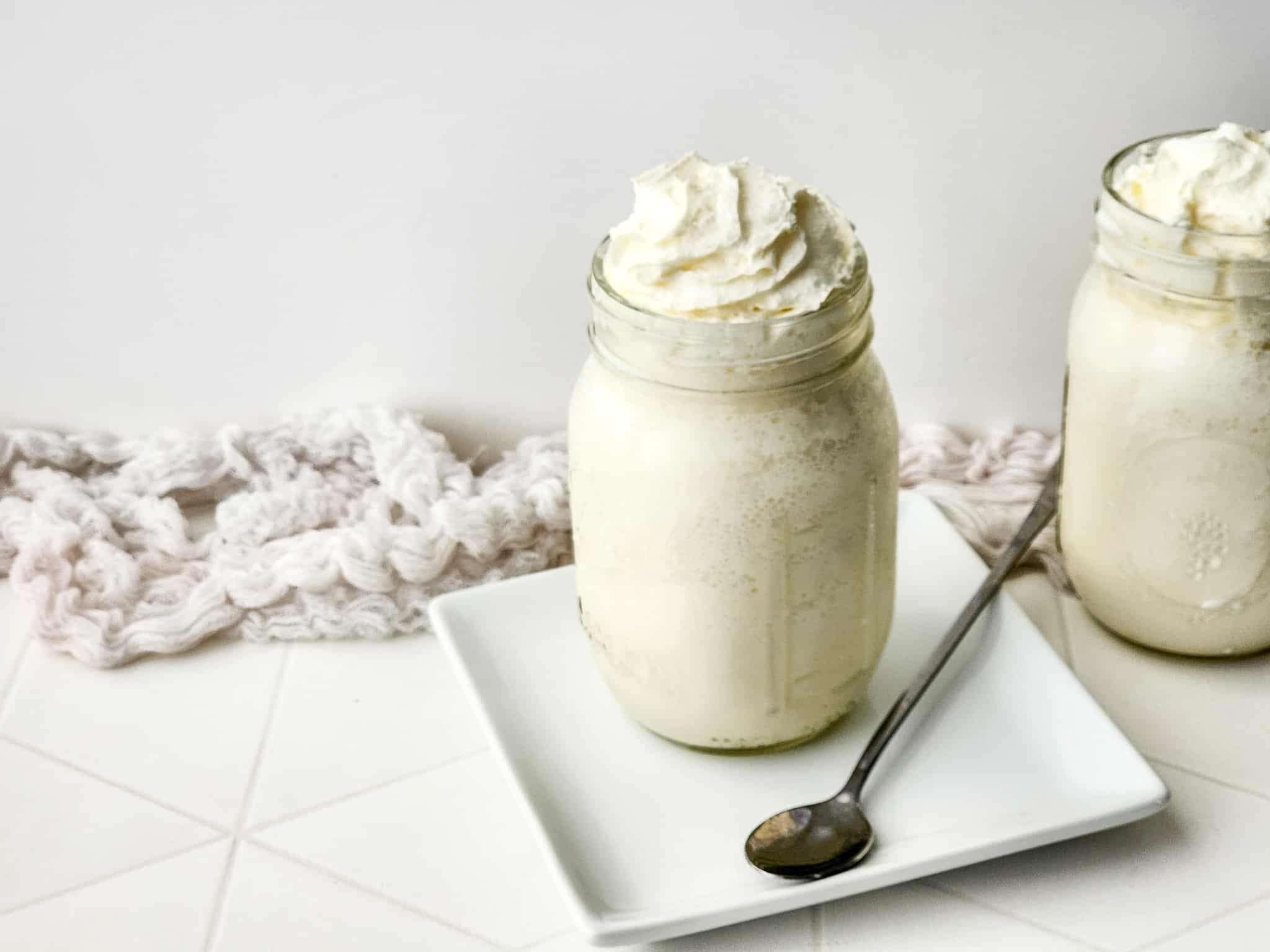 Vanilla Bean Frappuccino on a white plate with a silver spoon.