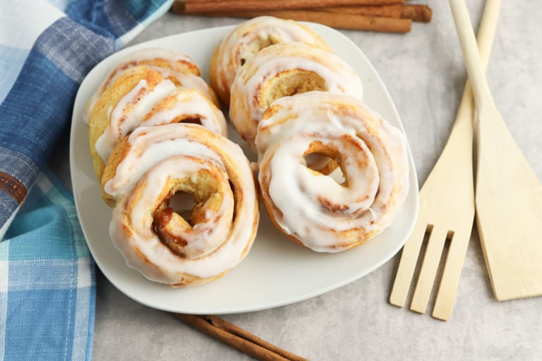 Air fryer cinnamon rolls on a white plate.