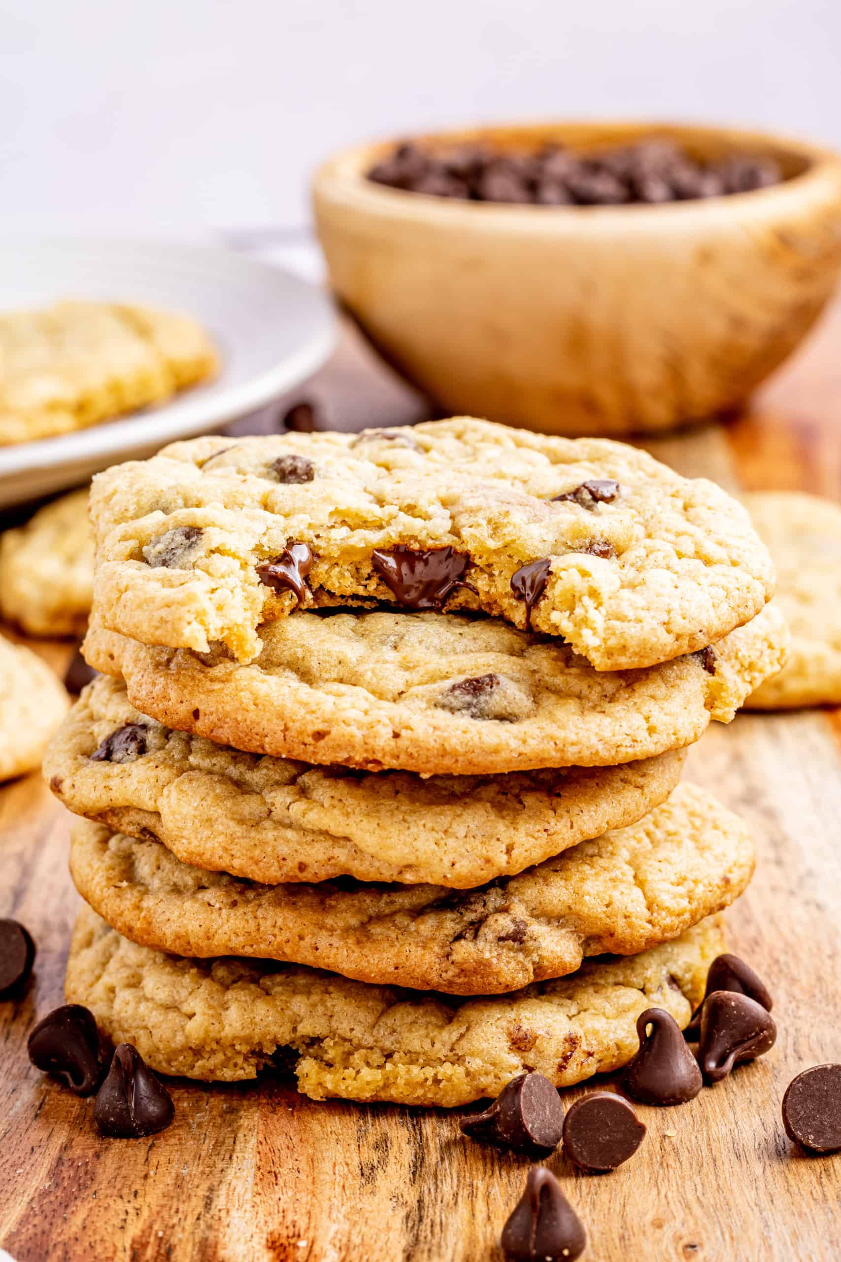 Stack of brown butter chocolate chip cookies, one with a bite out of it.
