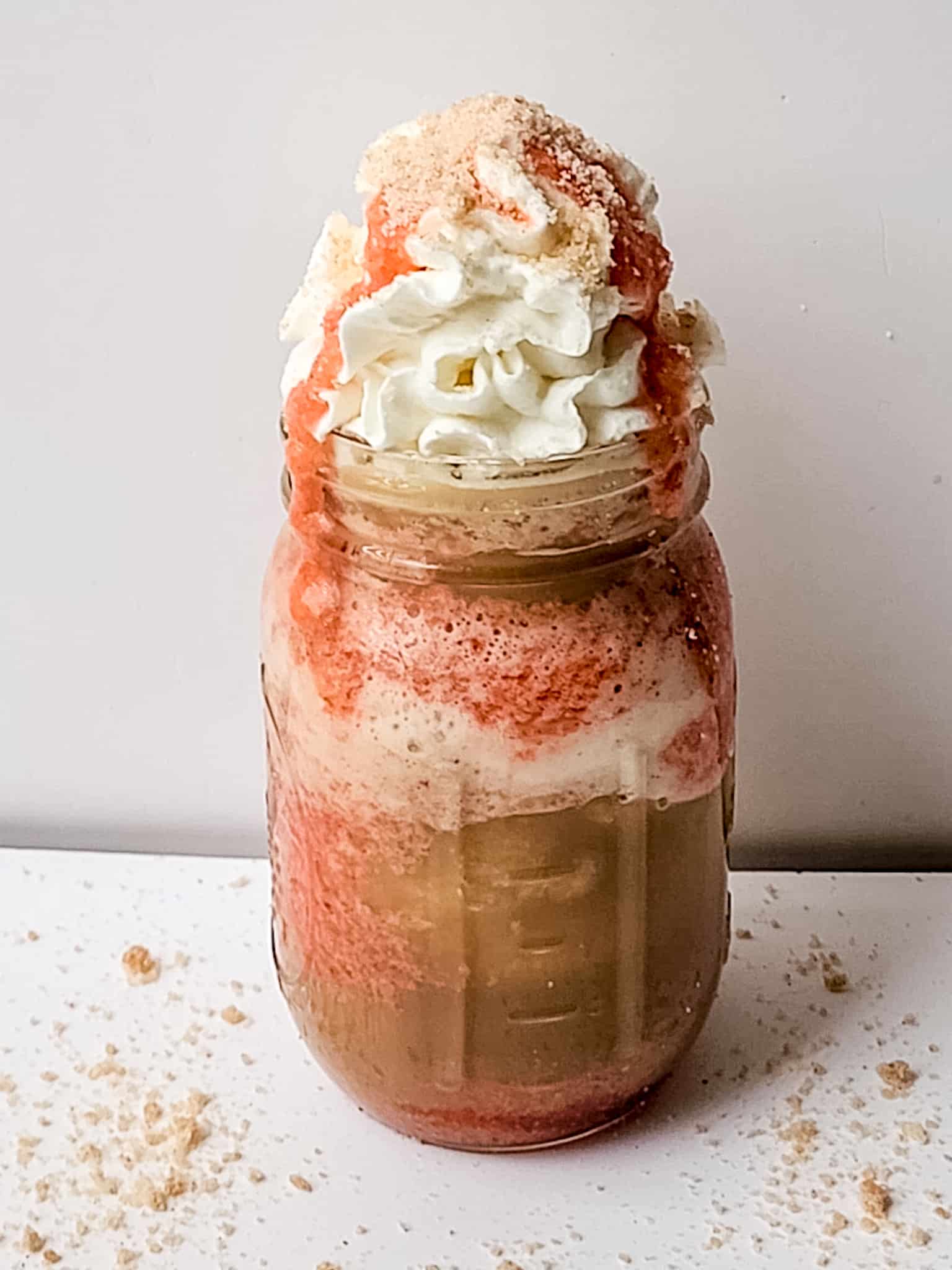 Headon view of layered strawberry fi=unnel cake frappuccino.