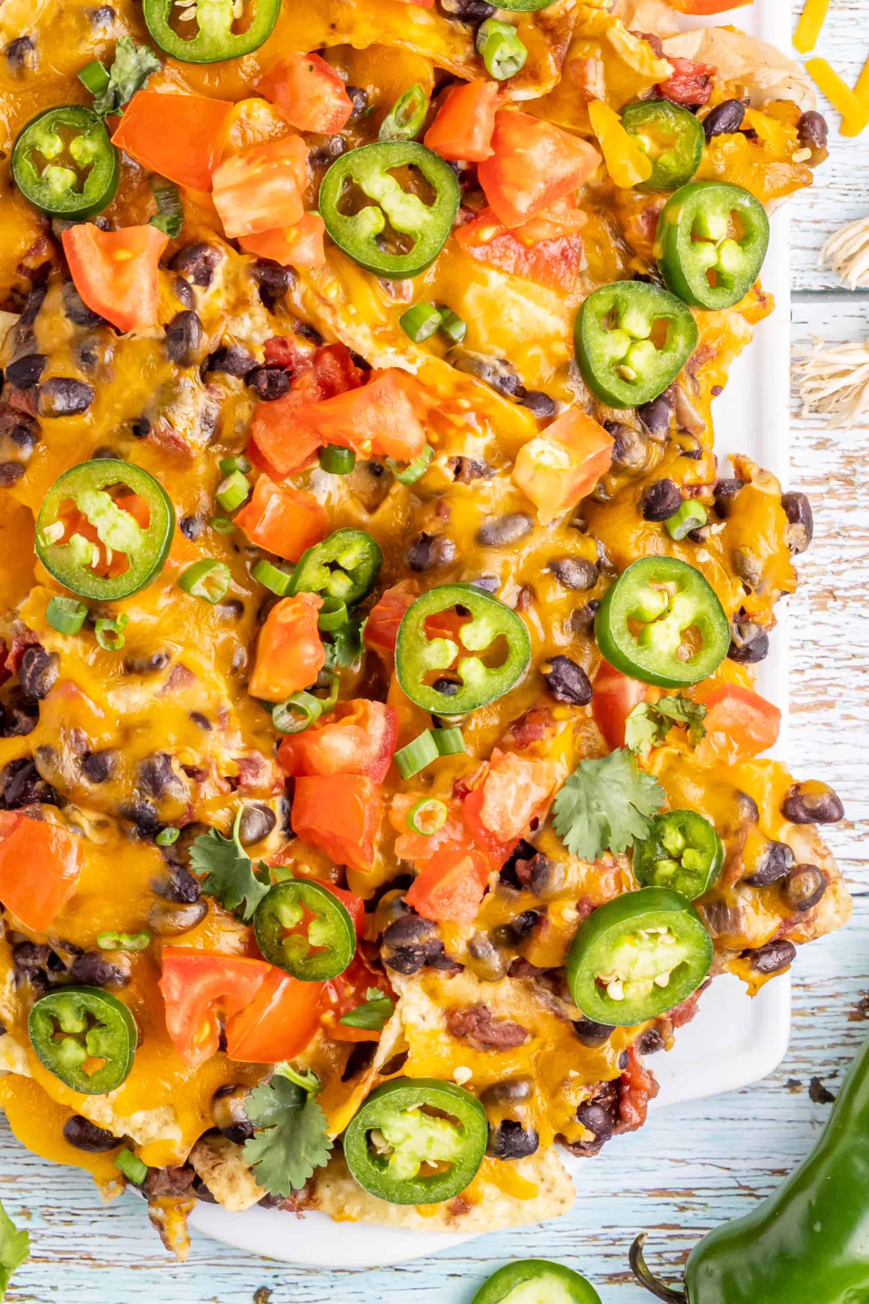 Loaded Black Bean Nachos with cheese and salsa..