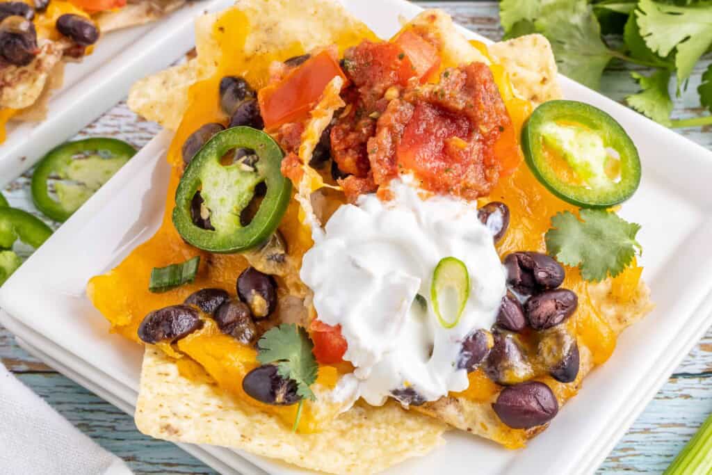 Spicy Black Bean Nachos on a white plate.