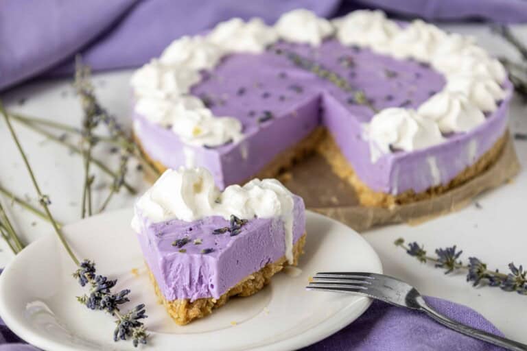Lavender Cheesecake with a slice out of it.