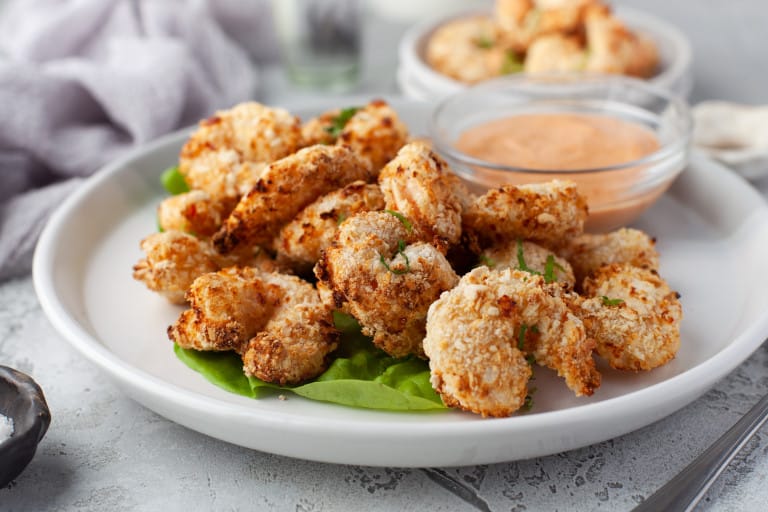 Fried Shrimp with sauce on a white plate.