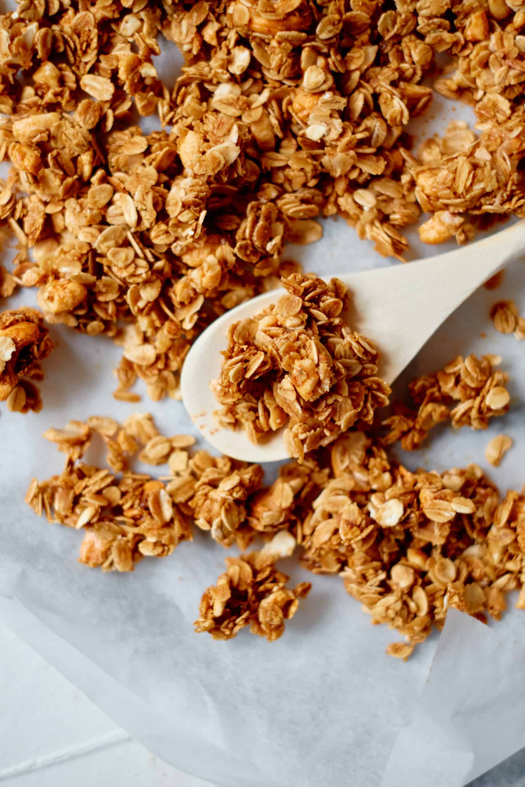 Pumpkin Spice Granola on a baking sheet lined with parchment paper.