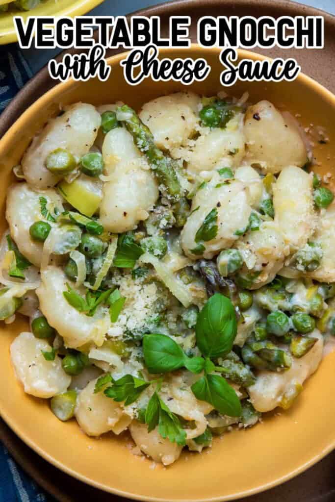 Overhead view Cheesy Gnocchi in a yellow bowl pin.