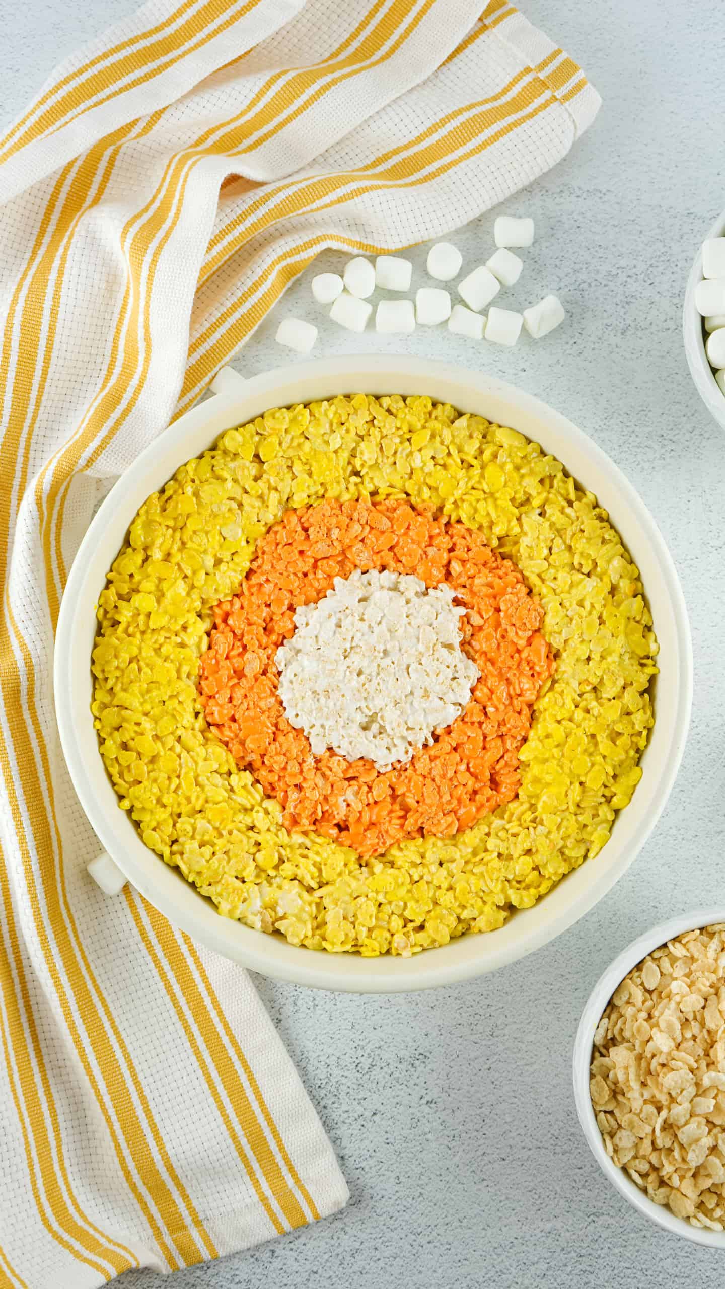 All three layers of candy corn trets in round dish.