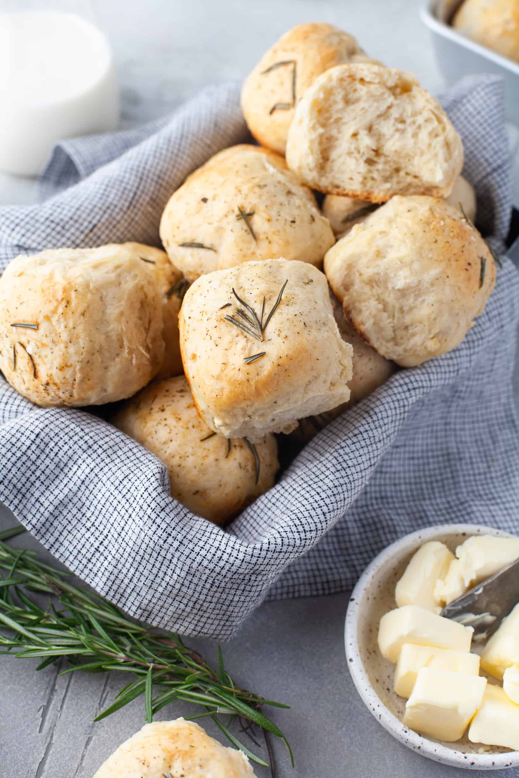 Rosemary garlic dinner rolls in a basket.